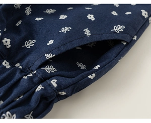 Detail of navy cotton pants showing side pocket stitching and elastic waist floral print