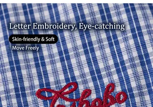 Detailed close-up of blue plaid cotton fabric with red script letter embroidery on the garment