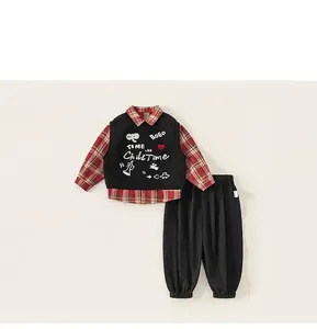 Detail view of boys' 3-piece set with red plaid shirt, black vest and joggers