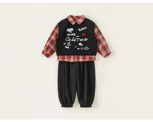 Detail of boys' 3-piece set featuring red plaid shirt, black embroidered vest and pants
