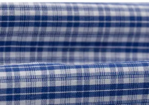 Close-up detail of blue and white checkered cotton fabric with fine texture and soft weave