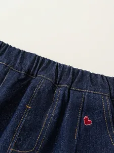 Pantalon en jean enfant bleu foncé avec taille élastique et broderie cœur rouge