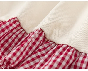 Close-up of girls' ribbed knit top with red and white plaid patchwork ruffles