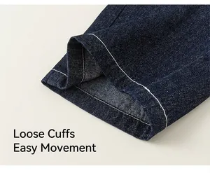 Detailed close-up of dark blue denim fabric texture and high-quality contrast stitching