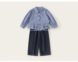 Detail of girls plaid shirt with ruffle hem and denim wide-leg pants outfit set