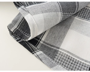 Detail of classic plaid fabric showing high-quality stitching and woven texture on boy's suit