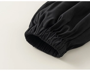 Detailed close-up of black elastic cuffs with fine twill texture for kids outfit set