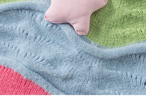 Detail of colorful knit fabric with pink star patch for kids fashion set