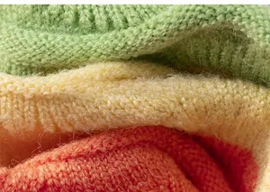 Macro view of cozy knitted colorful fabric with green, yellow and orange texture details
