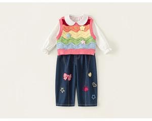 Detailed view of girls' rainbow wave knit vest with floral accents and white polka dot shirt