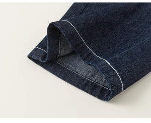 Detail of dark blue denim fabric with high-quality white contrast double stitching
