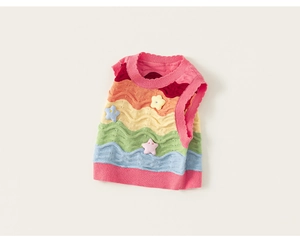 Detailed knit texture of a colorful rainbow striped children vest with 3D star patches