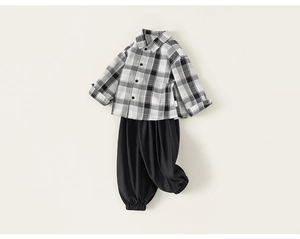 Flat lay of boys plaid button-down shirt and black jogger pants for a casual spring look