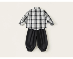 Macro shot of plaid long sleeve shirt and elastic cuff trousers on a beige background
