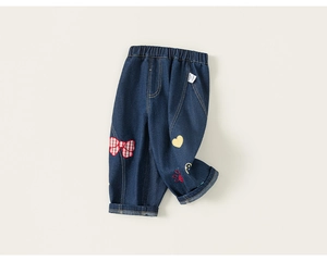 Detail of dark blue toddler jeans with elastic waist and cute colorful cartoon patches