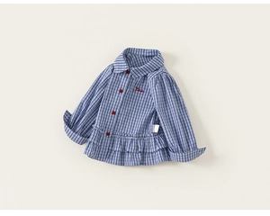 Detailed macro view of girls plaid shirt with blue gingham pattern and red buttons