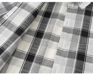 Close-up of black and white plaid shirt showing high-quality woven fabric and fine stitching