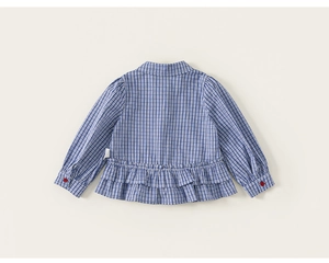 Detail of blue gingham shirt with red button cuff and ruffle hem for girls