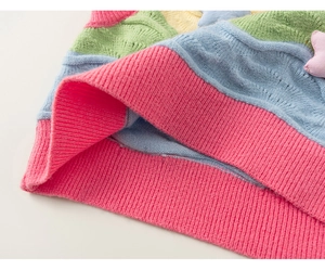 Detail of colorful knitted kids vest featuring ribbed hem and star patch decoration