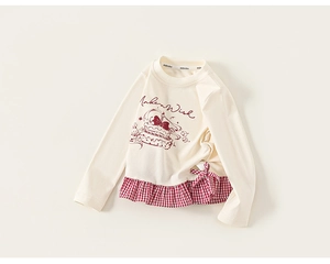 Detail showing red checkered patchwork hem and bow on girls long sleeve cotton T-shirt