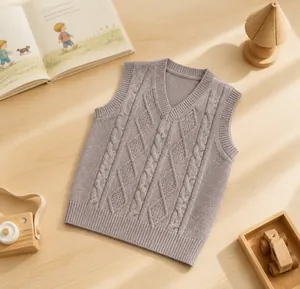 Detail of grey knitted vest for boys showing fine ribbed neckline and soft texture