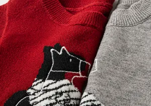 Macro detail of toddler knit vest showing premium cartoon embroidery and soft fabric texture
