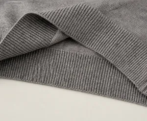 Detail view of the ribbed hem on boys gray knitted vest with high elasticity and soft texture