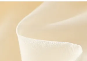 Close-up of white breathable cotton linen fabric texture on girls mesh dress