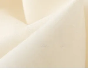 Detailed macro view of soft cream cotton linen fabric texture with breathable plain weave