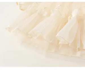 Detailed view of layered beige tulle skirt with delicate silver sequin embroidery