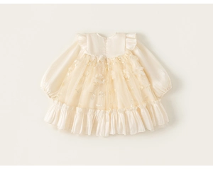 Detail of baby girl princess dress with elegant floral embroidery and ruffles