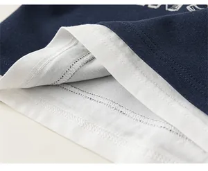 Detail of kids faux two-piece sweatshirt showing loose hem and precise double stitching