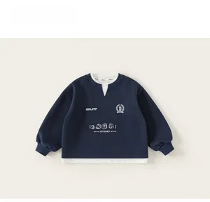 Detail of navy blue kids' sweatshirt with white layered effect and skateboards print