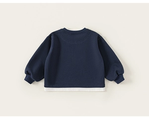 Detail of navy blue kids sweatshirt featuring a layered faux-two-piece white collar and hem