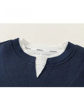 Detail of navy blue round neck sweatshirt featuring white layered collar and INSbobo tag