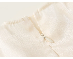 Macro detail of high-quality invisible zipper on champagne satin girls' dress fabric