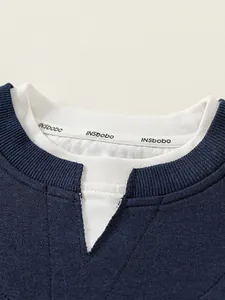 Navy blue faux two-piece sweatshirt with white collar and knit fabric texture details