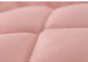 Close-up detail of pink quilted fabric with square padding and neat stitching for kids wear