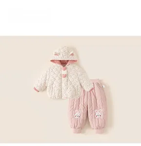 Detail of baby floral quilted jacket with rabbit ear hood and pink bunny embroidered pants