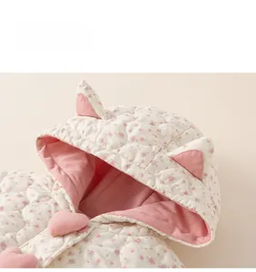 Detail of floral quilted hood with cute cat ears and warm pink fleece lining