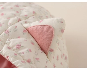 Detail of floral quilted fabric with cute cat ear accent and soft fleece lining