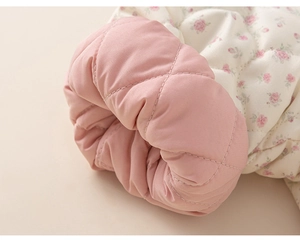 Detailed macro view of quilted floral cotton fabric with pink lining for kids jacket