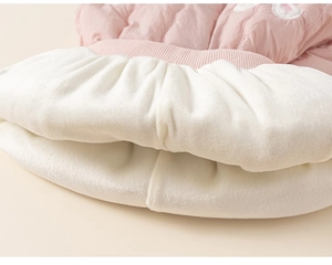 Close-up of pink quilted fabric with thick white fleece lining and ribbed waistband
