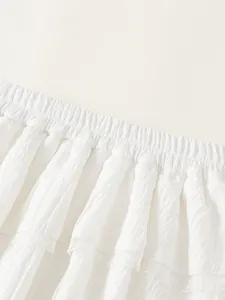 White girls' pleated skirt with elastic waistband and delicate lace trim detail
