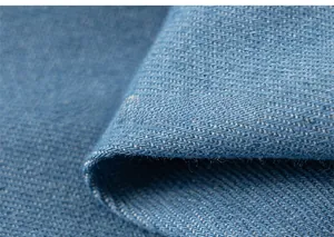 Detailed macro shot of blue denim fabric texture and twill weave on a girl's dress