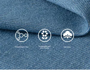 Close-up detail of soft blue plaid denim fabric with formaldehyde-free skin-friendly texture