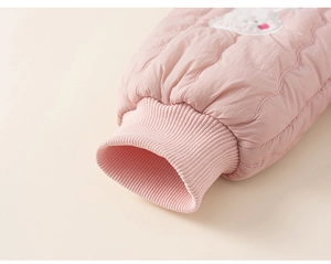 Close-up of pink quilted sleeve with ribbed cuff and cute white animal embroidery