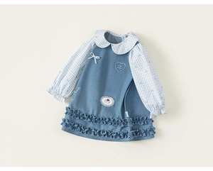 Detailed close-up of girls' denim jumper dress with Peter Pan collar and heart embroidery