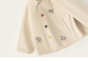 Detailed embroidery of dog and pony with colorful buttons on beige cotton jacket