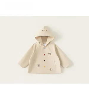 Detail of toddler hooded jacket with colorful buttons and cute animal embroidery motifs